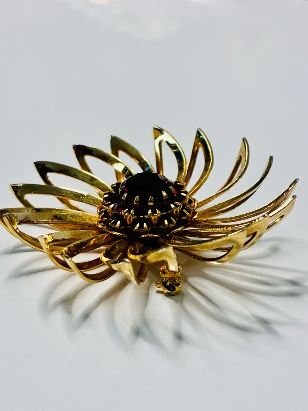 Sarah Coventry Gold-tone Sunburst Brooch with Deep Red Center